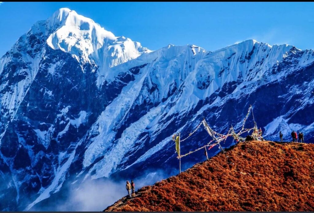Goechala Trek viewpoint with Mount Kanchenjunga and prayer flags in Sikkim