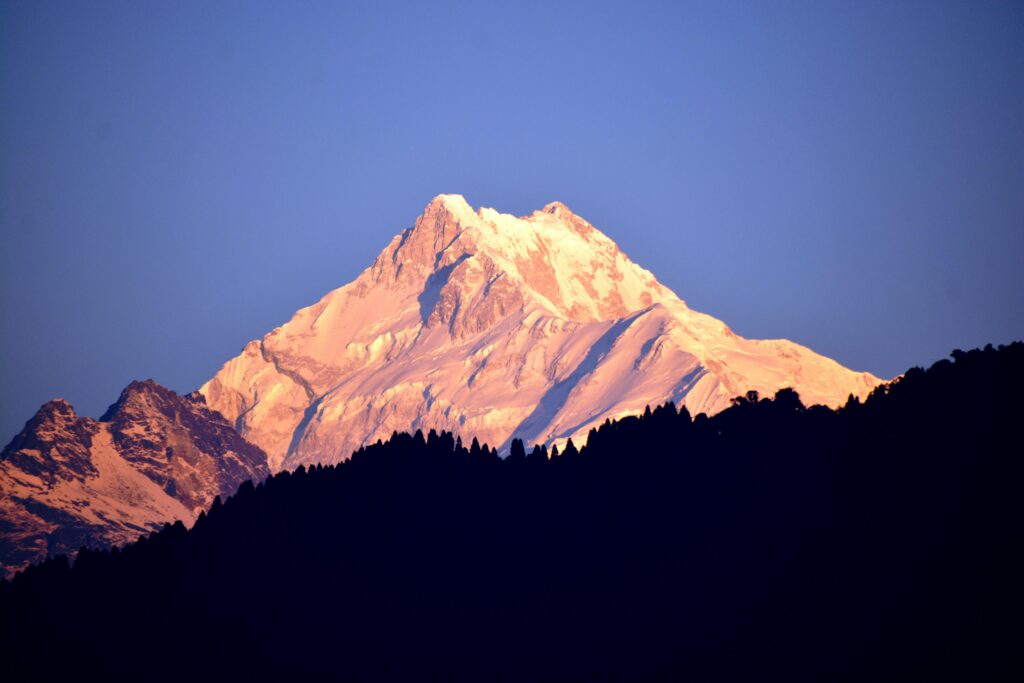 Sunrise view of Mount Kanchenjunga glowing in golden light from the Goechala Trek in Sikkim
