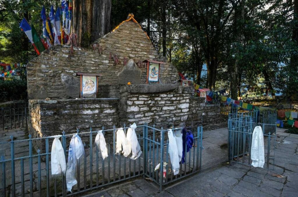 Norbugang Coronation Throne in Yuksom Sikkim surrounded by prayer flags and forest
